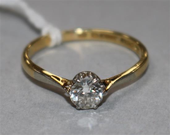 An 18ct gold, platinum and solitaire diamond ring, size M.